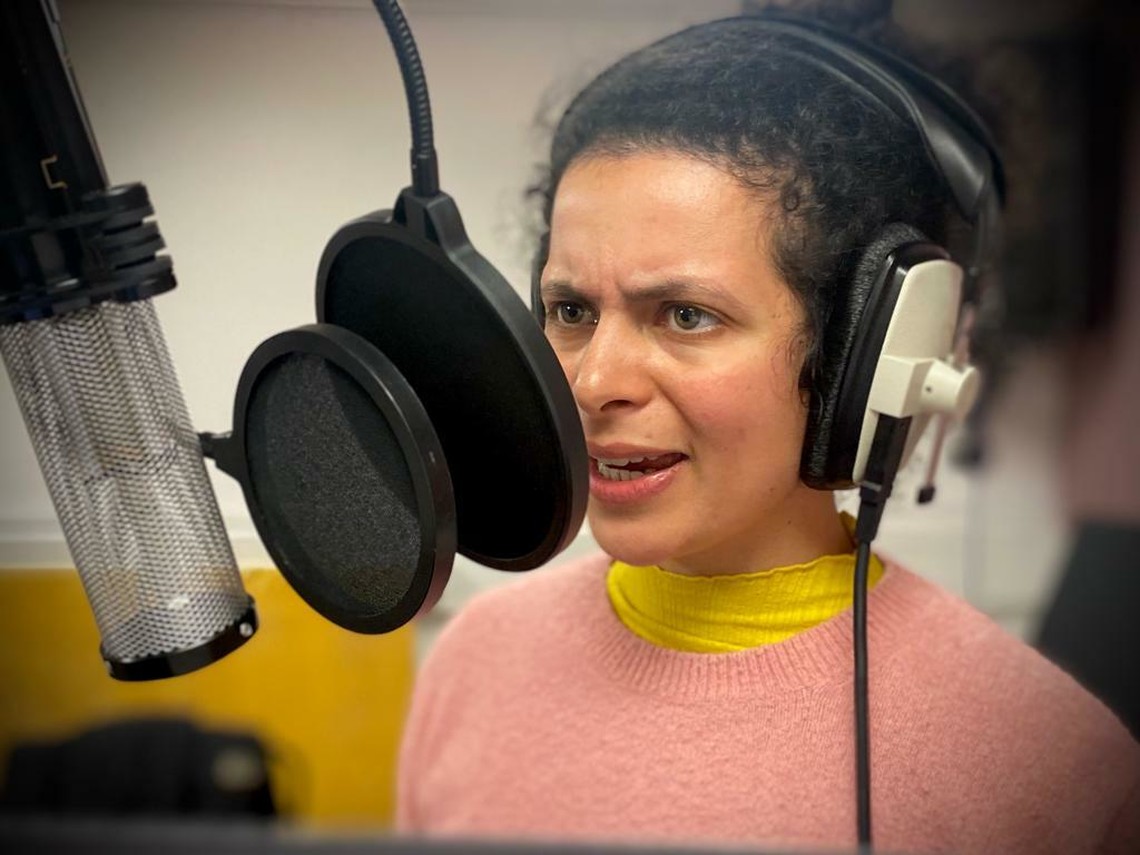 Actor recording their voice into a microphone